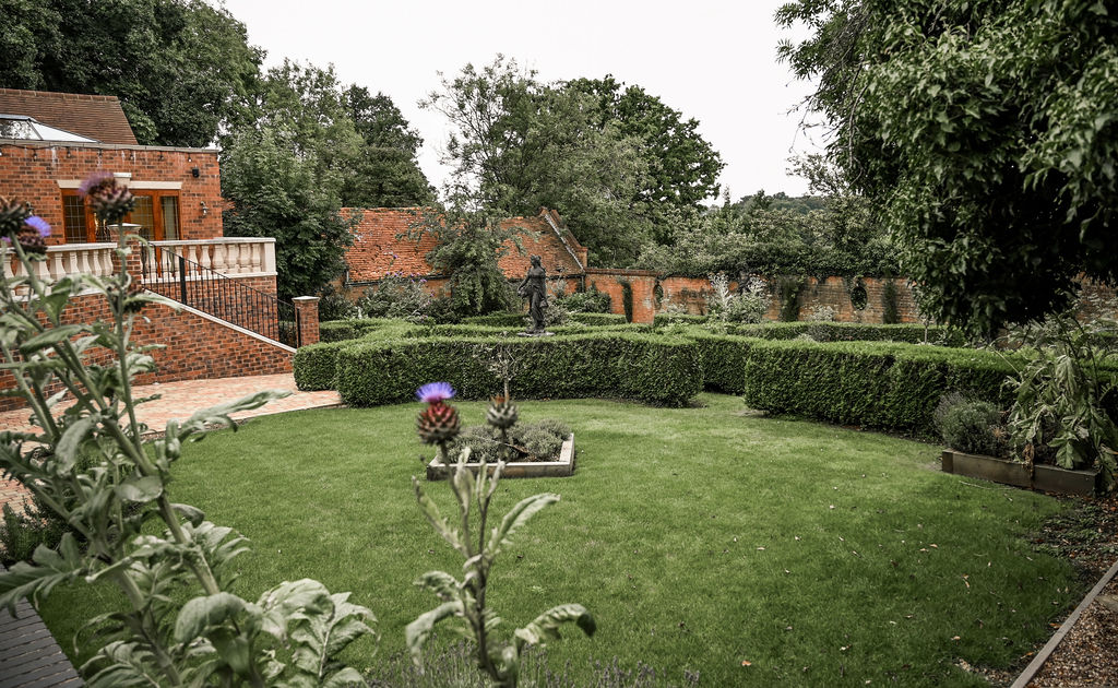 Picturesque herb garden outside the Stables barn at Nuthurst Grange Hotel