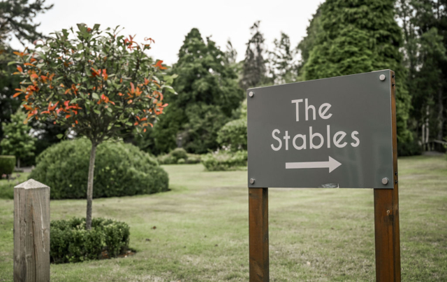 Sign pointing to the Stables barn function venue at Nuthurst Grange Hotel