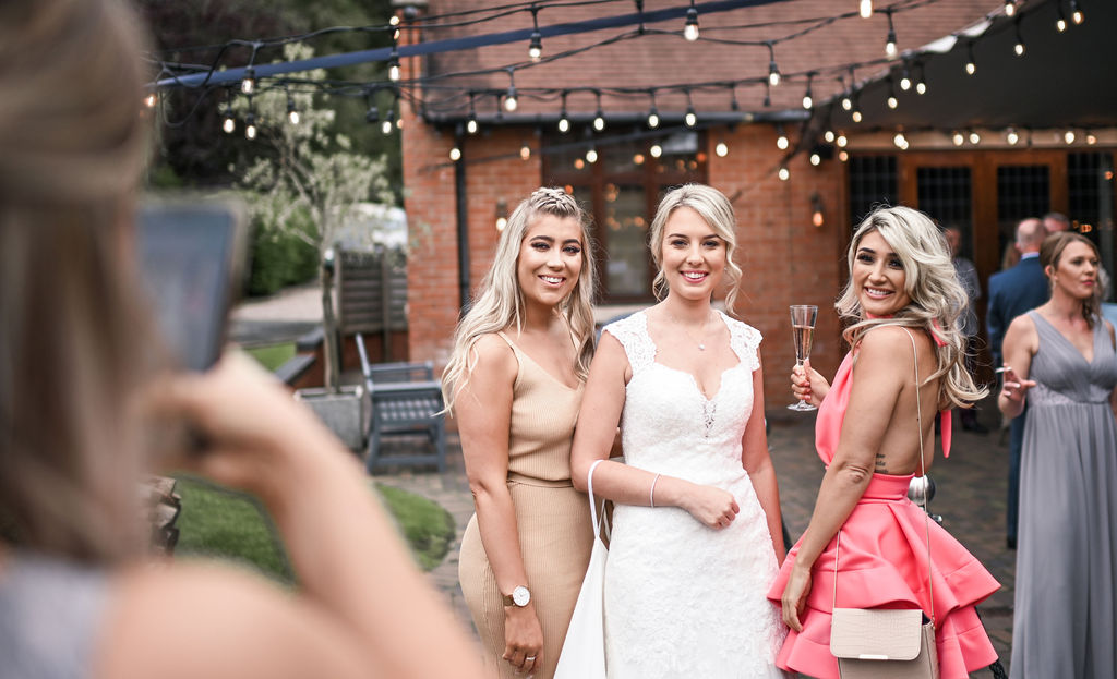 Bride and her friends are smiling at the camera at Nuthurst Grange